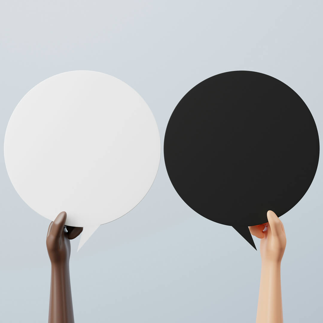 Hands holding two discs, one white and one black,